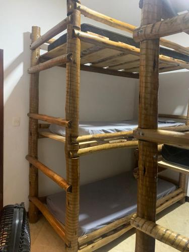 a stack of bunk beds in a room at Hostel e Camping Terapia Roots in Santa Teresinha