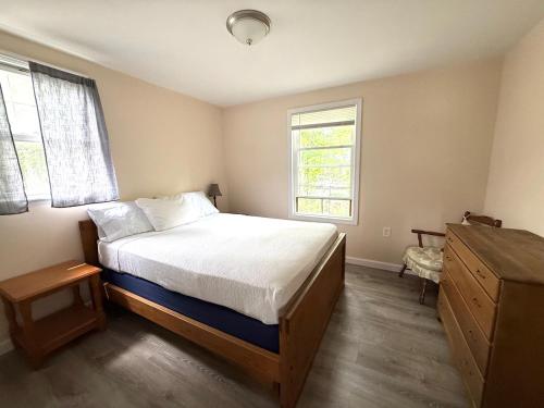 a bedroom with a bed and a window at Crosswinds Motel in Old Orchard Beach