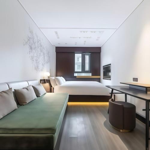 a hotel room with a bed and a couch at CitiGO Hotel Shanghai Xujiahui in Shanghai