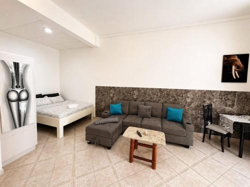a living room with a couch and a bed at CasaLoca Cabarete Studio Apartment in Cabarete