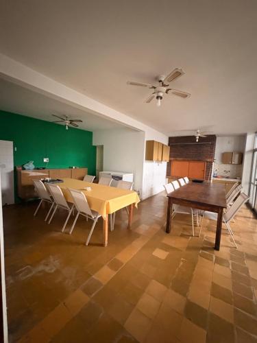 a dining room with a wooden table and chairs at Casa Encuentro in Pringles