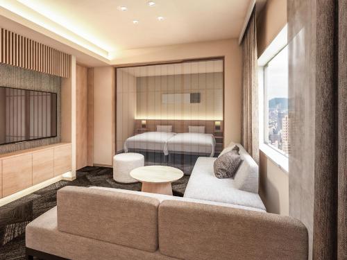 a living room with a couch and a bed at たびのホテルlit豊川 in Toyokawa
