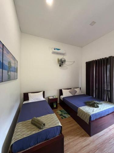 a bedroom with two beds and a fan at Riverston Hideaway in Matale