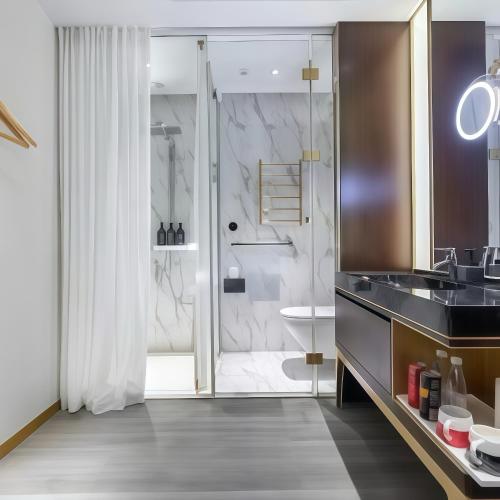 a bathroom with a shower and a sink at CitiGO Hotel Shanghai Xujiahui in Shanghai