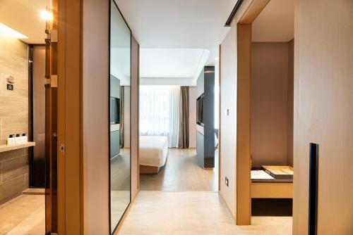 a hallway of a hotel room with a mirror at Atour Hotel Lanzhou Xigu in Lanzhou