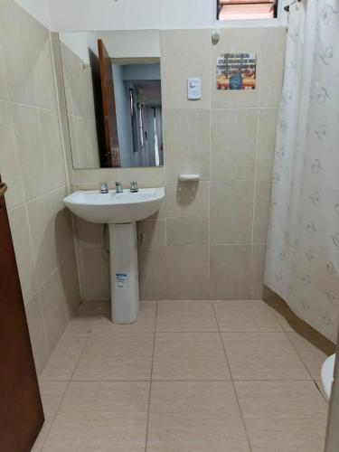 a bathroom with a sink and a mirror at Hospedaje Don Antonio 1 in Tinogasta