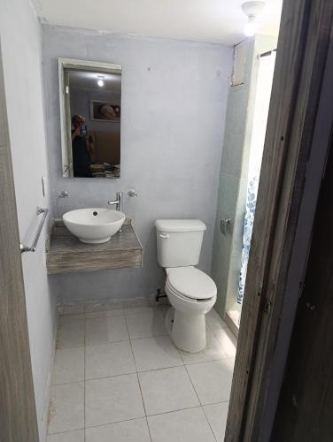 a bathroom with a toilet and a sink and a mirror at Departamento faja de oro in Salamanca