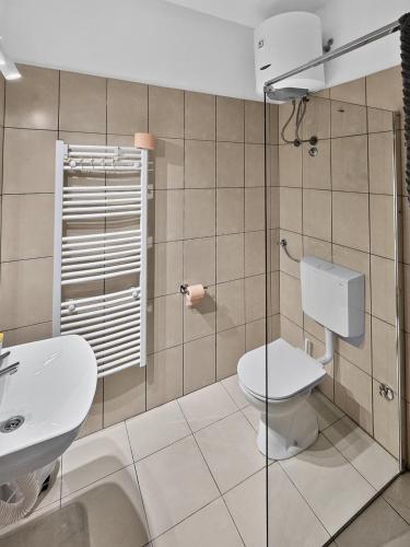 a bathroom with a toilet and a sink at ParkNest - Apartmani i sobe in Apatin