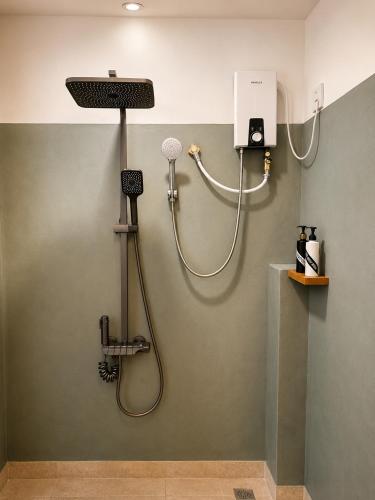 a bathroom with a shower with a shower head at The Oshin Villa in Trincomalee