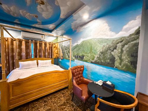 a bedroom with a bed and a painting on the wall at Thongtara House Boutique Srinakarin in Bangkok