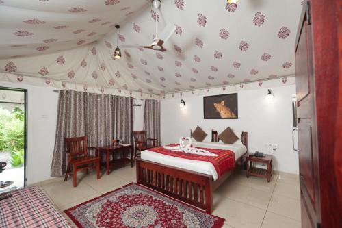 a bedroom with a bed and a table and chairs at Jawai Empire Resort by Premier Hotels - Luxury Tent & Cottage Stay - Leopard Safari Near Jawai Dam in Pāli