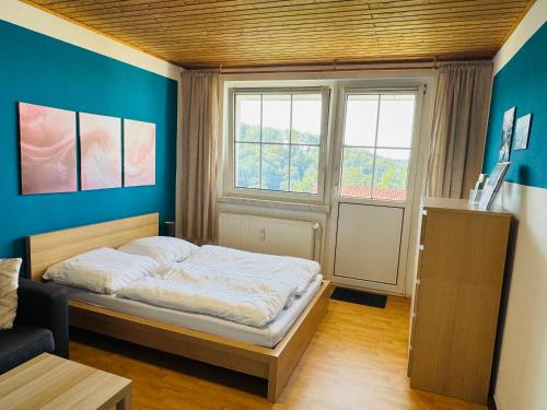 a small bedroom with a bed and a window at FeWo Einetal 1 im schönen Ostharz in Harzgerode