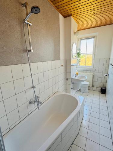 a bathroom with a tub and a sink and a toilet at FeWo Einetal 1 im schönen Ostharz in Harzgerode