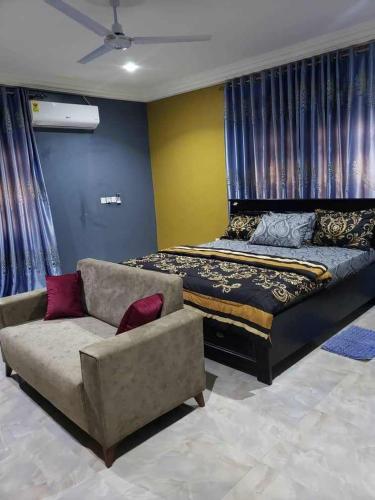 a living room with a couch and a bed at EdJames Lodge in Ashaiman