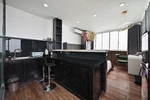 a kitchen with a black counter and a sink at M Home Riverside in Ho Chi Minh City
