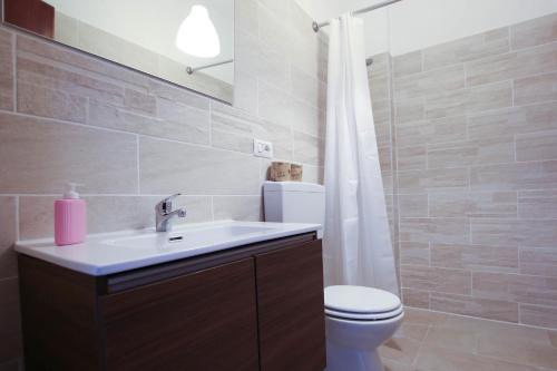 a bathroom with a sink and a toilet at VERETO apartaments Lecce in Lecce