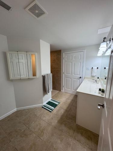 a white bathroom with a sink and a mirror at House in Hannibal in Hannibal