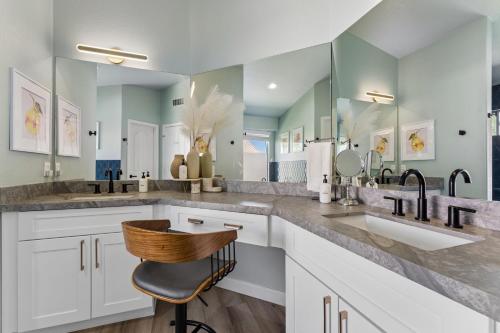 a bathroom with two sinks and two mirrors at Resort-Style 5BR Heated Pool Putting Green in Glendale