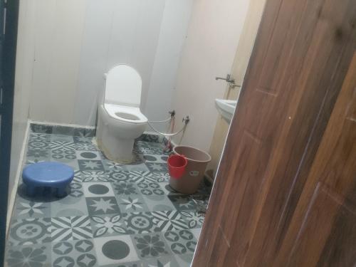 a bathroom with a toilet and a sink at Inaya resort in Phata