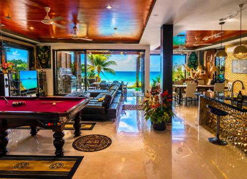 a pool table in a room with a view of the ocean at Villa Jacuzzi Seaview Villa in Chaweng Noi Beach