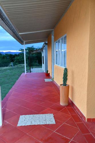 a porch of a house with a potted plant at HUAIRA Tatacoa in Villavieja