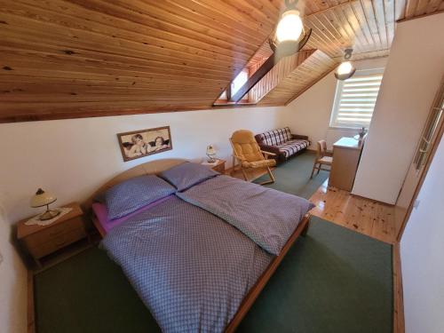 a bedroom with a bed and a living room at Dom Wakacyjny MONA in Małe Swornigacie