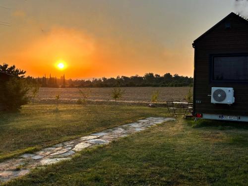a view of the sunset from the back of a rv at Dolce Casa 1 by Tiny Away in Arezzo