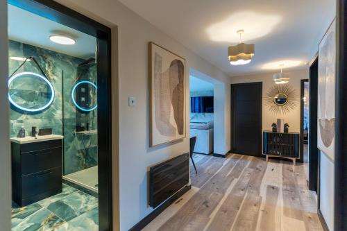 a bathroom with a shower and a sink and a mirror at Gleneagles Village Penthouse in Tullibardine Station