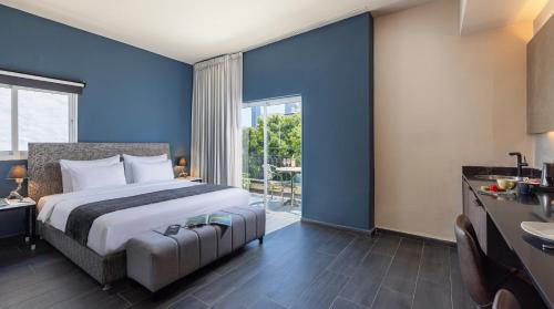 a hotel room with a bed and a large window at Dizengoff Avenue Boutique Hotel - by Echo Hotels in Tel Aviv