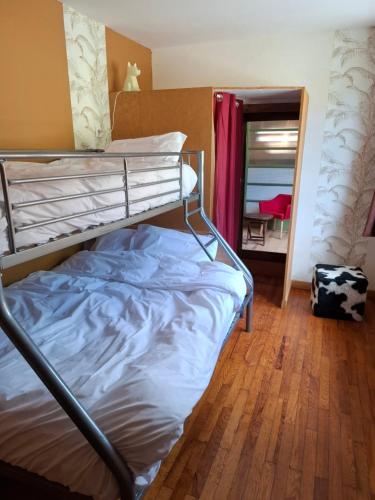a bunk bed in a room with a wooden floor at OAK Familly in Saint-Racho