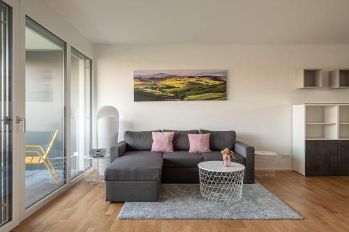 a living room with a couch and a table at Ferienwohnung Badespaß am Schlosssee Salem in Salem