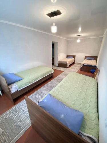 a bedroom with two beds and a couch at Family nest in Kochkorka