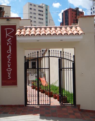 a gate to a building with plants behind it at Rendezvous Hostal in La Paz