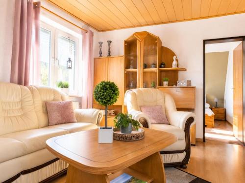 a living room with a couch and a table at Dünenlounge Dornumersiel in Dornum