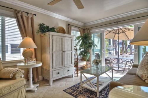 a living room with a cabinet and a table at San Clemente - Monterey C in San Clemente