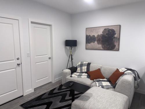 a living room with a couch and a chair at A very cozy 2-bedroom apartment in Calgary