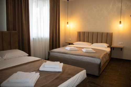 a hotel room with two beds with towels on them at Luna in Solotvyno