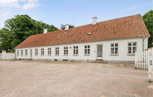 a large white building with a red roof at 2 Bedroom Nice Apartment In Skanderborg in Skanderborg