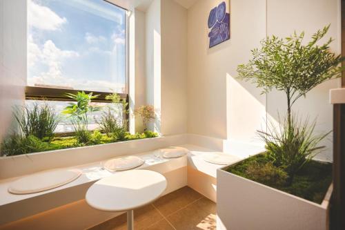 a bathroom with two toilets and a window with plants at Mumum Jongno in Seoul
