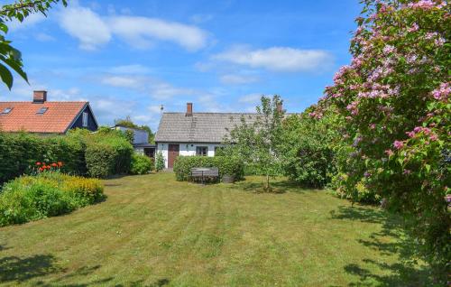a house with a yard with flowers at 3 Bedroom Pet Friendly Home In Löderup in Löderup