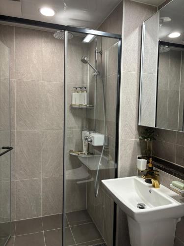 a bathroom with a glass shower and a sink at 광안리 써니 스테이 #무료주차 in Kwangan-dong