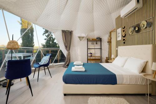 a bedroom on a yacht with a bed and a chair at Geo heaven glamp in Aïtánia