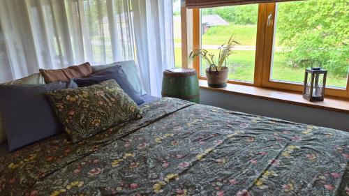 a bedroom with a bed and a window at Partsi Veski in Partsi