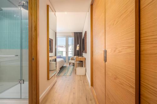 a hallway with a glass door leading to a bedroom at Hyatt Regency Lisbon in Lisbon