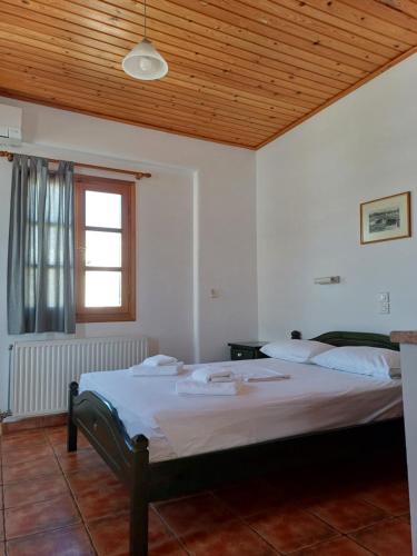 a bedroom with a large bed in a room at Siroco's Rooms And Studios in Parikia