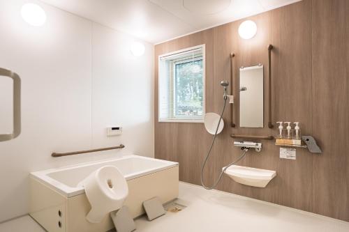 a bathroom with a sink and a toilet and a mirror at u10 -ユーテン- in Kakegawa