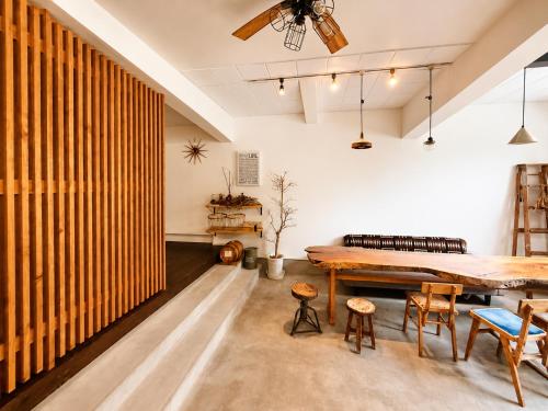 a room with a large wooden table and chairs at 出雲大社まで徒歩5分 一棟貸し宿 はれいろ in Izumo