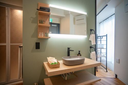 a bathroom with a sink and a mirror at ORI Ikebukuro in Tokyo