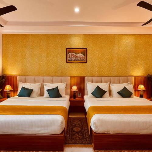 two beds in a hotel room with two lamps at Hotel La Casa, Amritsar #swimming pool #prime location #luxury rooms #best selling hotel near golden temple in Amritsar