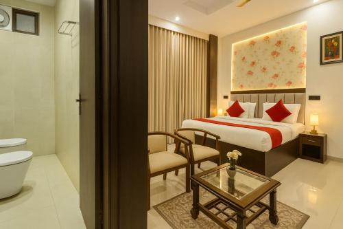 a hotel room with a bed and a toilet at Hotel La Casa, Amritsar #swimming pool #prime location #luxury rooms #best selling hotel near golden temple in Amritsar
